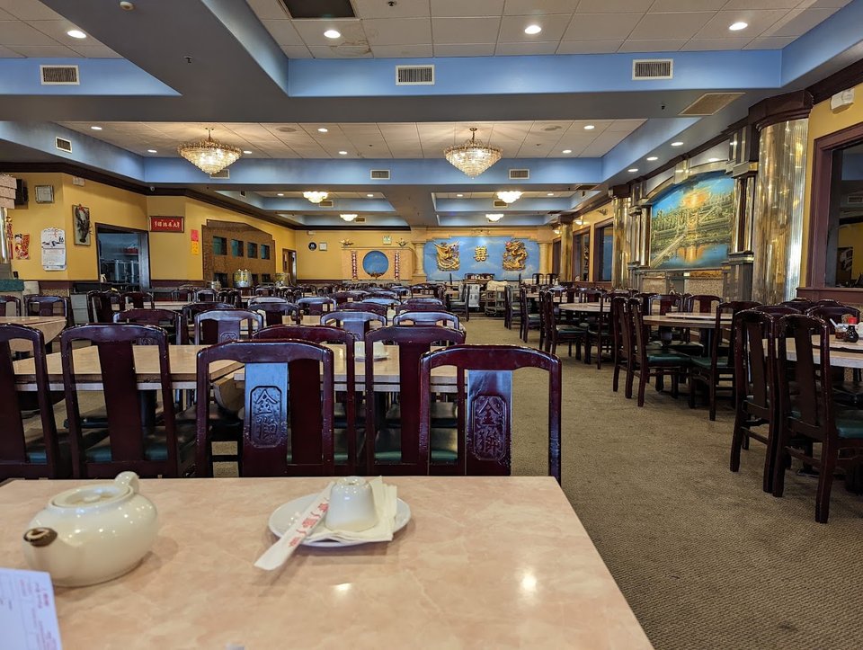 Spacious dining room with large round tables.